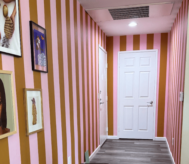 Boutique hotel lobby with premium patterned wallpaper, cozy seating, and warm lighting, creating a luxurious and personalized guest experience